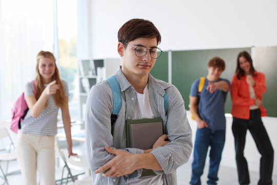 Students bullying their classmate in classroom, selective focus