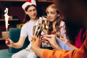 Friends celebrating new year with champagne and sparkler