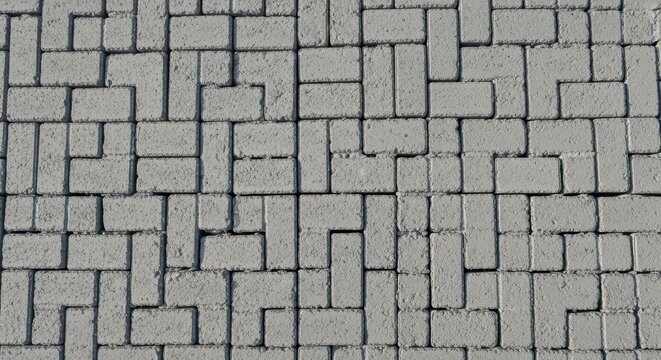 Gray interlocking concrete paving stones with geometric pattern - Powered by Adobe