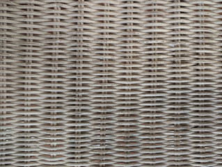 Woven rattan or wicker close-up of old chair seat painted white. Furniture surface, wear, age, paint chipping, basket-weave pattern, weathered material, distressed, worn, rustic background texture.