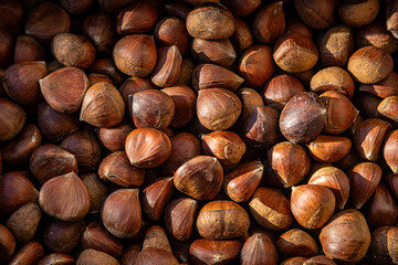 A full frame photograph of chestnuts for sale on a market stall