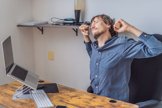 A man working from home in his organized home office, focused on his laptop in a bright modern workspace. Remote work, productivity, freelance lifestyle and contemporary global workplace concept - Powered by Adobe