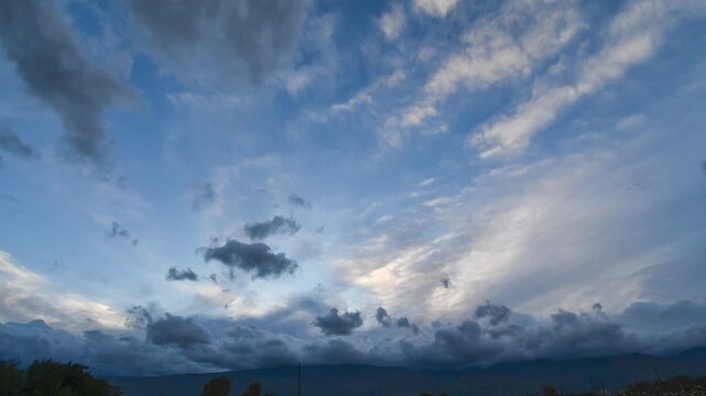Time lapse footage of clouds over the field of corn. In the distance of the horizon mountain.