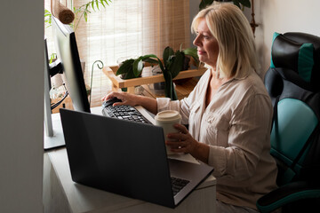 Senior woman working from home office using computer