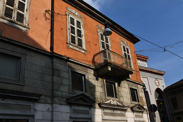 A lively scene from the city of Vercelli with bustling streets and a vibrant market. The image...