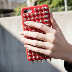 Red Spiked Phone Case in Hand
