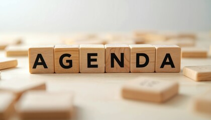 Wooden letter blocks clearly spell word AGENDA on clean, light wood surface. Image conveys strong concept of business planning, important meetings, future schedules, daily task organization. Also