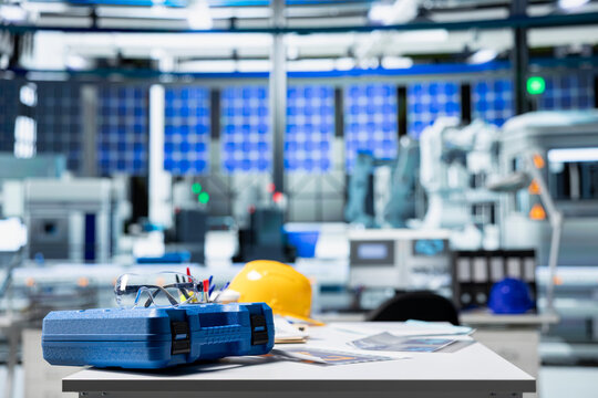 Desk setup used for producing renewable energy in high tech facility, tracking solar panel assembly line progress. Photovoltaics factory engineering workspace to ensure seamless production.