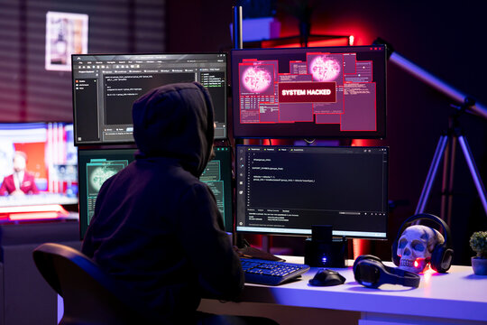 Cybercriminal receiving system hacked message after attacking victims PCs using computer virus. Lone wolf hacker in secret lair trying to hide online activity after stealing data