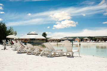 Recreation complex with sun loungers and a covered tent with a pond