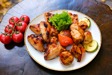 Honey mustard glazed grilled chicken breast meat and fresh vegetable salad with lettuce, tomato, top view, copy space. Healthy keto lunch recipe, fitness menu. High quality photo