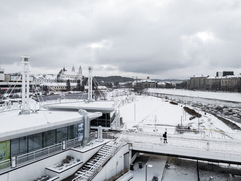 Aerial view of snow-blanketed landscape with the Neris River winding through the city, showcasing the stark winter contrast against the backdrop of Vilnius Cathedral., Vilnius, Vilnius, Lithuania.