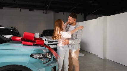 Husband surprising wife with new car gift at dealership