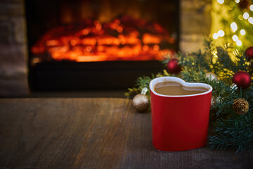 Cozy Hearthside Mug. Heart-shaped mug by a warm fireplace with holiday decor.