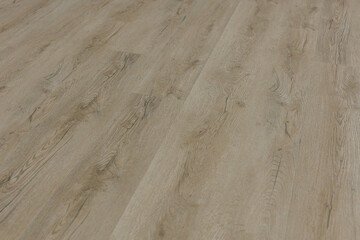 Fototapeta premium Warm natural-light interior scene showing textured wood flooring, captured close-up to highlight grain patterns and surface detail for home renovation and design themes.