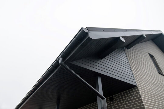 Black PVC gutter system with downspout