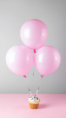 Pink balloon background holiday cupcake celebration with pastel balloons floating above decorated cupcake creating festive joyful scene