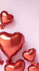 Bright red heart balloon against soft pink background creating romantic holiday mood with shiny reflections and floating festive decoration
