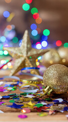 Sparkling gold ornament star background balloon holiday festive confetti on wooden table with colorful bokeh lights creating joyful seasonal celebration