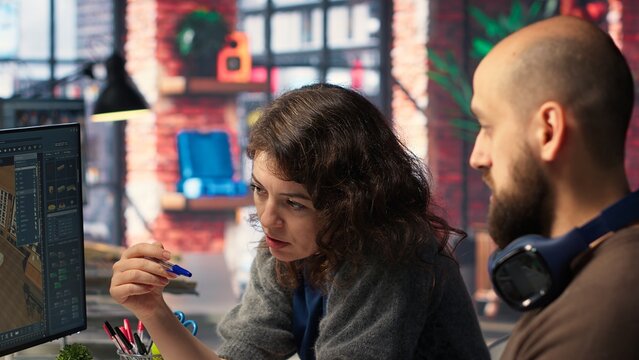 Designers team works on remodeling project using architectural software on PC to configure room layouts. Program allows to drag and drop elements or assets, adjusting virtual furniture. Camera B. - Powered by Adobe