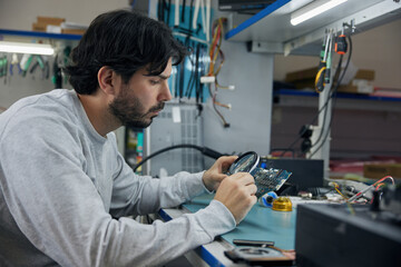 A man is working on an electronic device project
