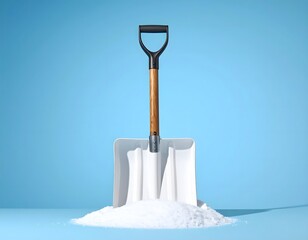 A snow shovel stands upright in a pile of white snow against a blue background.