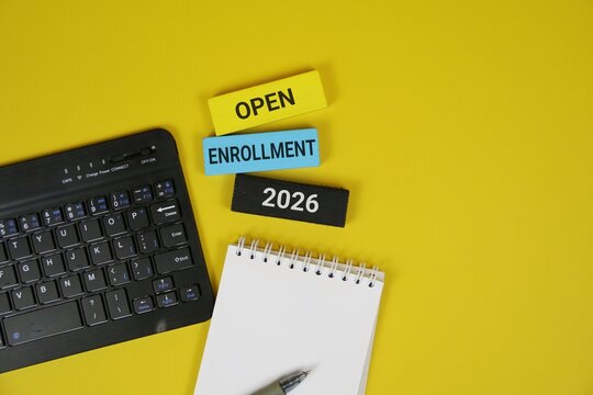 Yellow background featuring a laptop keyboard, spiral notebook, and pen, with colorful blocks showing Open Enrollment 2026. Great for education, courses, and business enrollment themes.