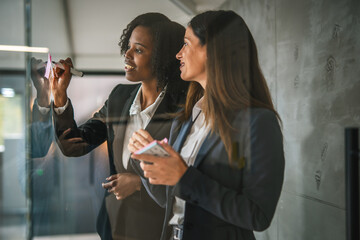 Businesswomen collaborating on ideas during office meeting