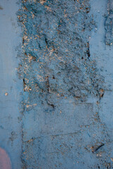 Rough blue painted cement wall texture with cracked plaster surface