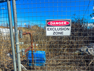 Photograph of a Danger Warning Sign on a fence barricade notifying people not to enter a small construction site in regional New South Wales, Australia. 