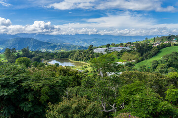 View from roadside in Cartago province of Costa Rica with small lake and tomato growing farms