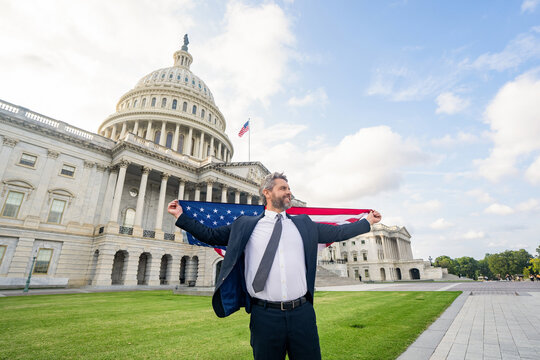 Man with American flag. Politician on independence day. Successful career in USA. Leadership and success. Successful political leader. Businessman at US Capitol. Businessman in Washington DC - Powered by Adobe