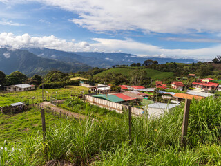 View from roadside in Cartago province of Costa Rica with farm buildings and small village
