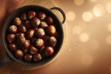 Roasted chestnuts in a cast iron pan on a wooden board with warm bokeh background