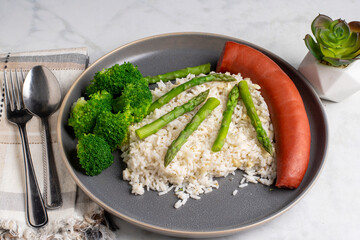 smoked sausage  with rice  top with asparagus