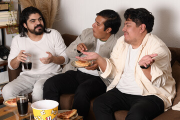 Three friends having a lively discussion while sharing snacks