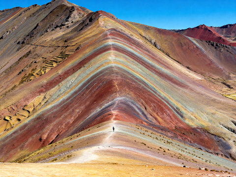 a panoramic view of the rainbow mountain, with its surface displaying a dangling, colorful pattern - Powered by Adobe