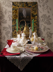 beautifully decorate the table with dishes for a festive New Year's backdrop