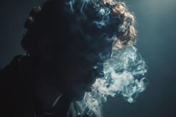 Man exhaling smoke in dark low key lighting