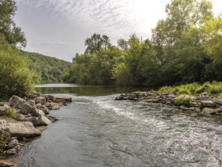 River with a rocky bank and trees in the background