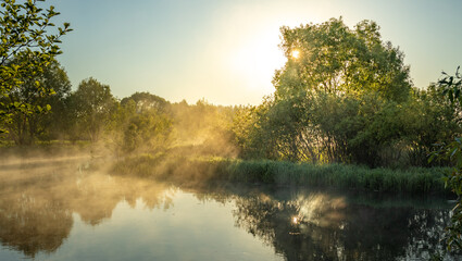 The sun is shining on the water, creating a beautiful reflection