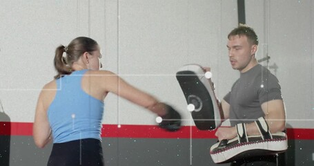Coach signaling target, trainee practicing boxing combos in gym, holding focus mitts guiding speed - Powered by Adobe