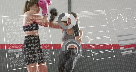 Two women training in gym, partner angling pads, pink gloves hitting mitts, HUD centering over pair - Powered by Adobe