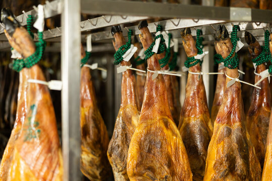 Legs of traditional Spanish jamon ready for sale in grocery