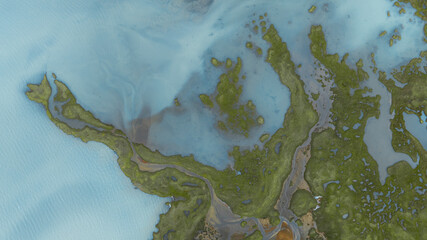 Aerial view of turquoise waters meeting lush green landscapes, creating a mesmerizing contrast of colors and textures in Landmannalaugar, Rangarping ytra, Iceland.