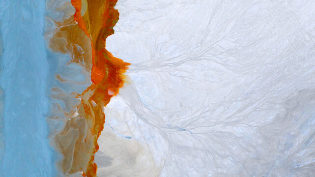 Aerial view of vibrant, rust-colored waters contrasting sharply against the pale, branching patterns of the landscape, creating a surreal and otherworldly scene, Ríotinto, Andalusia, Spain.