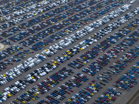 Aerial view of neatly arranged rows of vehicles creating a mesmerizing pattern of color and form, Sloegebied, Zeeland, Netherlands.