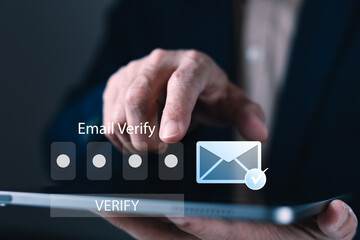 Businessman tapping tablet to verify email with code, showing secure login process, digital identity, and email authentication technology