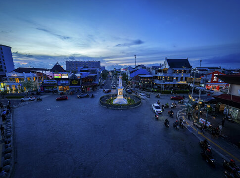 Aerial view of the iconic Tugu Jogja monument standing proudly amidst the bustling roundabout, bathed in the ethereal glow of twilight, Yogyakarta, Daerah Istimewa Yogyakarta, Indonesia.