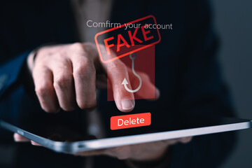 Businessman detecting fake phishing alert on tablet with red warning icon and delete button for online scam prevention and cybersecurity awareness